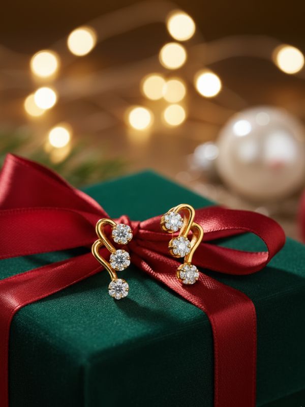 AuDiam 18K gold diamond cling earrings – Christmas gift for her with red ribbon on a green gift box against a blurred festive background