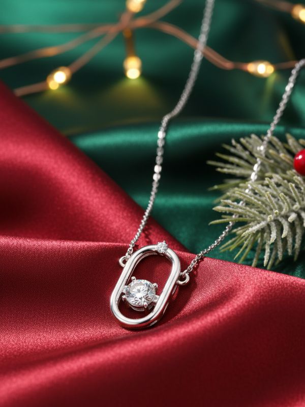 AuDiam Accessible Luxury – 1 diamond pendant – Christmas gift for her on a red fabric background with Christmas decorations.