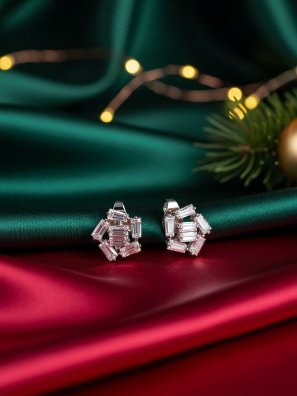 AuDiam Minimalist Baguettism diamond earrings – Christmas gift for her on a green and red fabric background with festive lights and decorations.