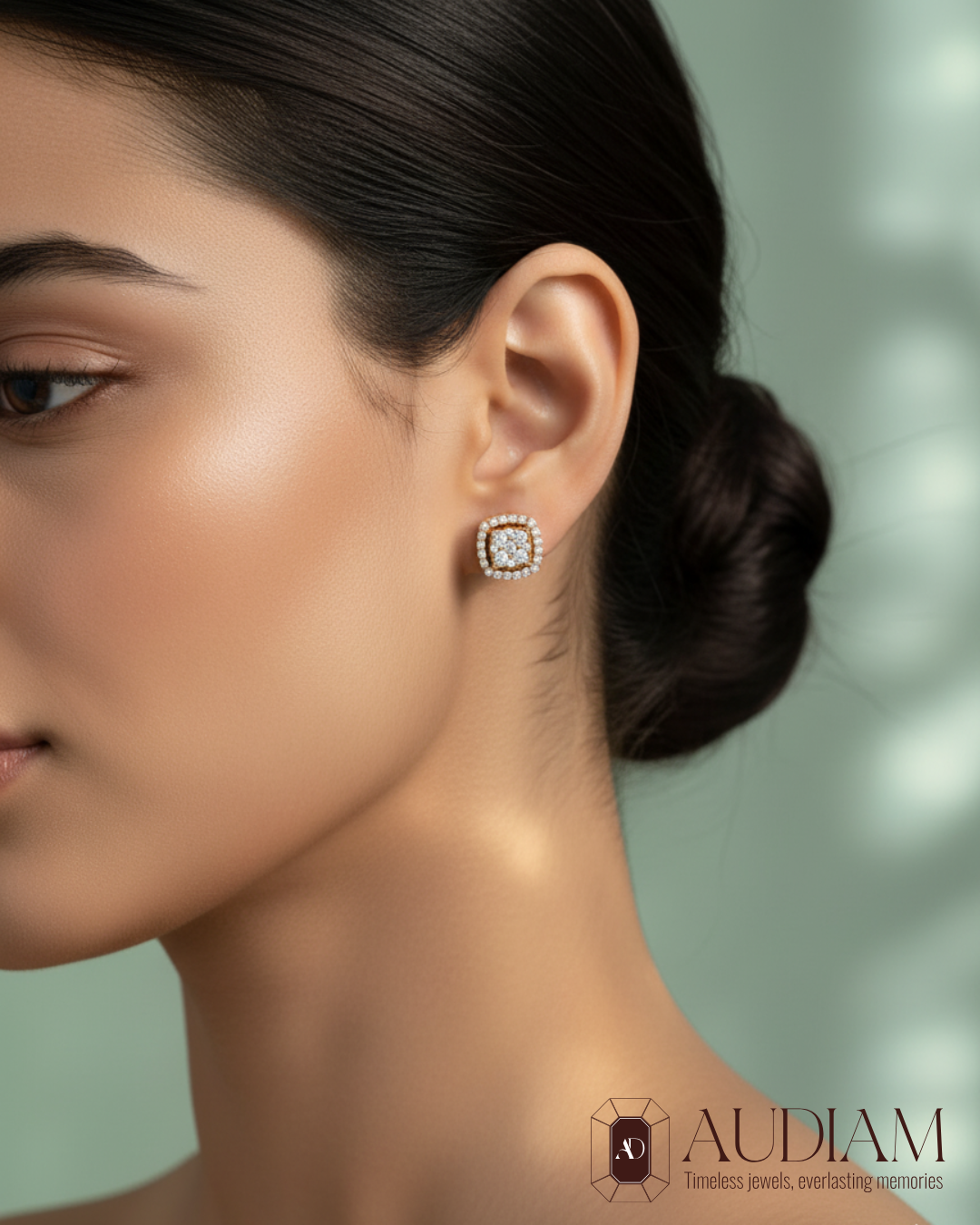 Elegant model showcasing AuDiam CS Illusion Square diamond stud earrings in 18K gold, timeless square halo sparkle with the Audiam logo.